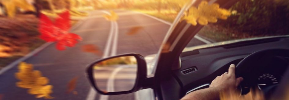 a car driving through the mountains during fall